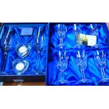 A pair of boxed Avola Blue Collection large crystal champagne flutes with white metal twist design