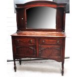 An early to mid 20th century mirror back oak sideboard the base with two drawers over two