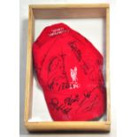 A Liverpool Football Club UEFA Champions League cap bearing the team logo and numerous signatures