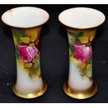 A pair of Royal Worcester hand painted and gilded vases with flared rims and decorated with roses