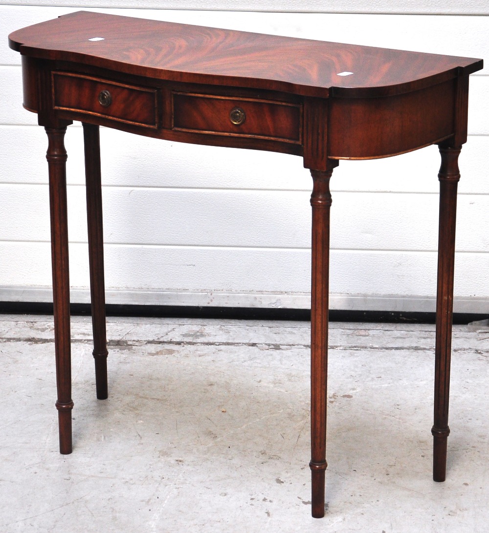 A reproduction half moon shaped hall table on square section tapering legs with lower tier and a