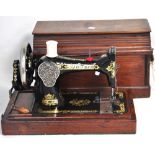 A cased vintage sewing machine.