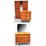 A retro 1970s Austin suite to include four drawer chest of drawers raised on tapering legs and a