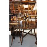 A mid 20th century Ercol drop leaf dining table with four matching stick back chairs (5).