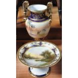 A Noritake hand painted gilt heightened comport decorated with swans on a tranquil river, diameter