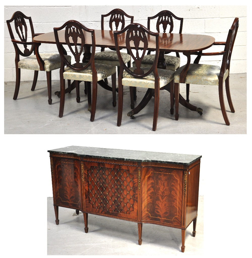 A reproduction mahogany dining room suite comprising twin pedestal crossbanded dining table with