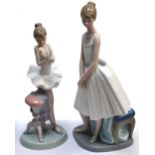 Two Lladro figures of ballerinas one holding a spray of flowers.