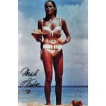 Ursula Andress; a signed coloured photograph of the actress in her role as Honey Ryder, with