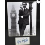 George Lazenby; a black and white photograph of the actor in his role as James Bond, signed and