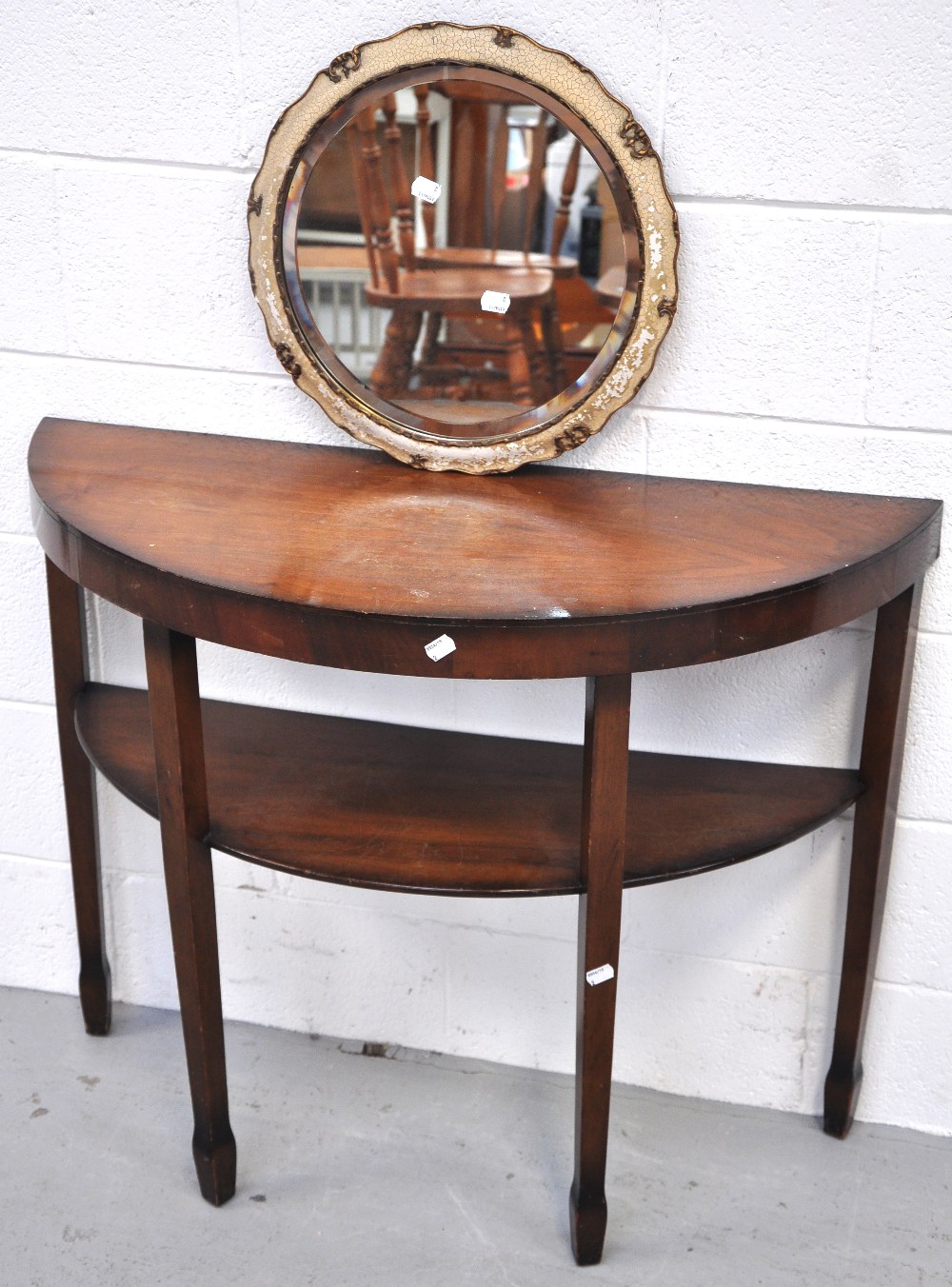 A modern mahogany hall table and a modern round bevelled edge mirror (2).