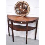 A modern mahogany hall table and a modern round bevelled edge mirror (2).