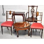 A circular walnut occasional table with glass top on claw feet, two matching mahogany and inlaid