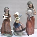 Three Lladro figures; a girl holding a pot of flowers, a girl holding a large bonnet and a figure