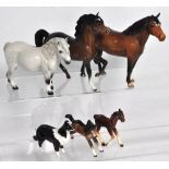 A Royal Doulton grey Shetland pony, two Beswick horses (one with front leg repaired), a miniature