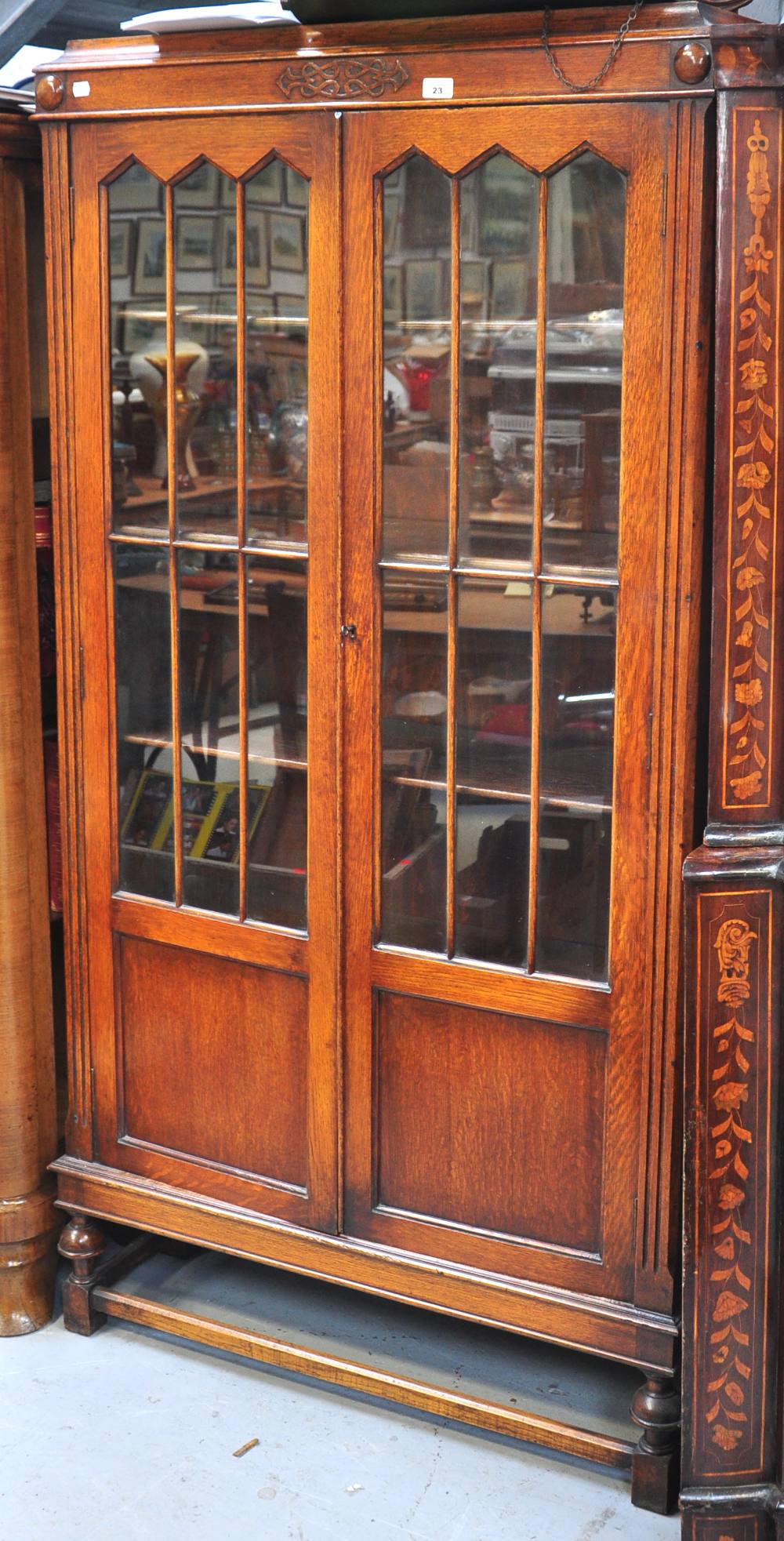 A mid 20th century oak part glazed two door book case on square section legs and stretchers, 180 x