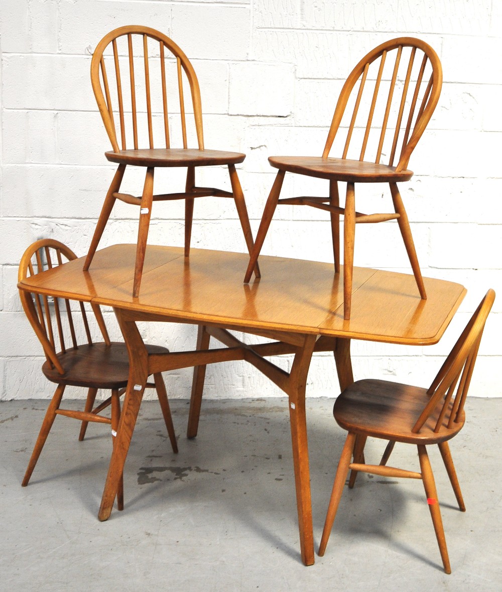 A retro 1970s light oak Ercol style dining table with twin flaps, together with four matching