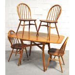 A retro 1970s light oak Ercol style dining table with twin flaps, together with four matching