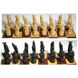 A composite chess set carved in the form of Chinese figures.