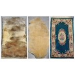 An Oriental rug, a mohair rug and a sheepskin rug (3).