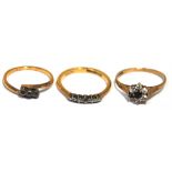 Three 9ct gold dress rings; three stone, five stone and floral set (floral set missing one stone)