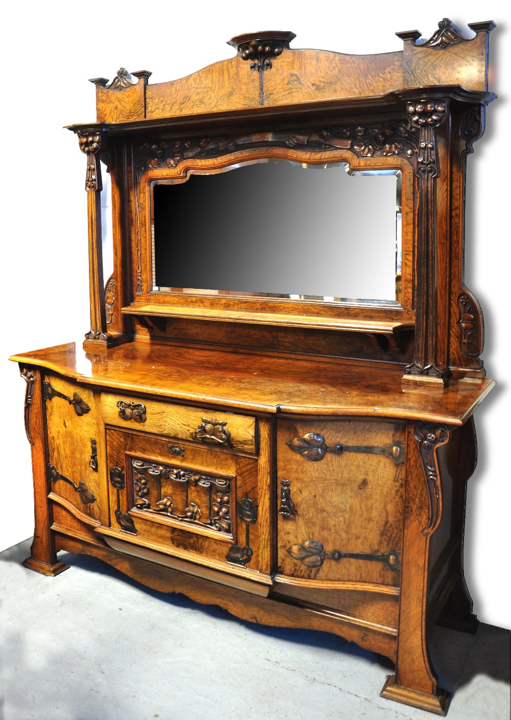 A good c.1900 Art Nouveau walnut and pollard oak mirror back sideboard, the raised back with two