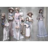 Two Nao figures of girls one holding a flower basket and one holding a dog and five Lladro figures