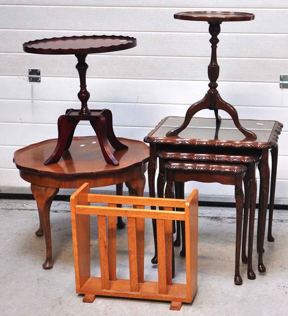 A modern nest of three occasional tables, a reproduction occasional table, a magazine rack and a