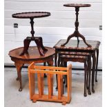 A modern nest of three occasional tables, a reproduction occasional table, a magazine rack and a
