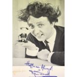Ken Dodd; a signed promotional black and white photograph with printed signature recto and