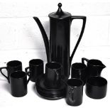 A retro six piece black glazed coffee set comprising cups saucers and coffee pot.