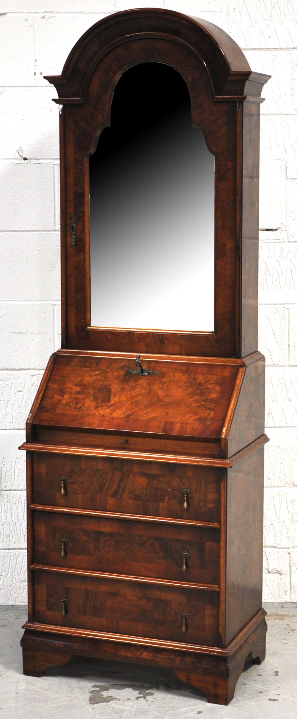 A reproduction walnut and crossbanded dome topped bureau bookcase of small proportions, the upper