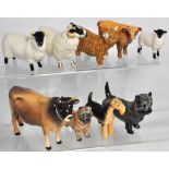 A Royal Doulton grey terrier, two Beswick rams, a Beswick sheep, a Beswick bull, a Beswick calf, a