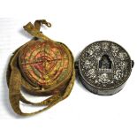 A white metal Tibetan travel shrine in carrying pouch, diameter 11cm.