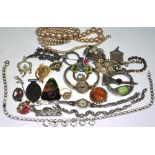 A quantity of costume jewellery to include a silver and marcasite brooch and a vintage silver and
