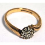 A 9ct gold diamond cluster crossover ring, size O, approx weight 3.2g.