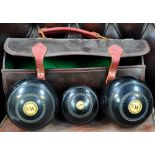 A leather cased set of bowls by Thomas Tailor of Glasgow, a pair of Dumme's Lake Placid speed