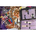 A quantity of costume jewellery to include necklaces, brooches and  rings etc.