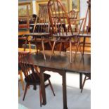 A 20th century oak dining table with fluted legs, length fully extended 148cm and five priory comb