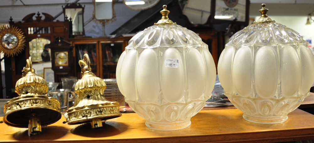 A 20th century oak standard lamp and two glass globe and gilt metal hanging light shades (3).