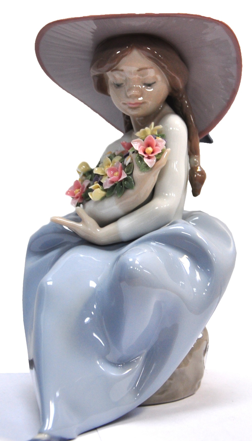 A large signed Lladro figure of a young girl in a sun bonnet holding a large bouquet of flowers,