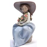 A large signed Lladro figure of a young girl in a sun bonnet holding a large bouquet of flowers,