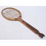 A late 19th/early 20th century rare fish tail handled tennis racquet with original stringing,