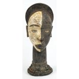 A Kongo funerary head, Democratic Republic of the Congo, the face painted half white, half black,