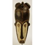A Fang mask, Cameroon, with elongated face and applied pigmentation,