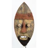 A Krou (Grebo) mask, Ivory Coast, the ovoid form set with raised lips,