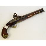 A late 18th century flintlock pistol with walnut stock and brass furniture, and face mask to the