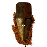 An Adouma Mvudi plank mask, Gabon, with polychrome decoration and natural fibre beard, height 58cm,