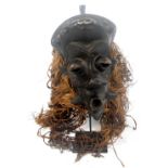 A Luluwa mask, Democratic Republic of the Congo, with raised features and with fibre coiffeur,