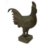 A large 17th century Benin bronze model of a cockerel with incised decoration and rounded square