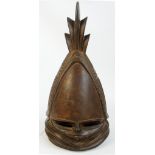 A Mende "Sowei" helmet mask, Kenema Region, Sierra Leone, set with scarified detail,